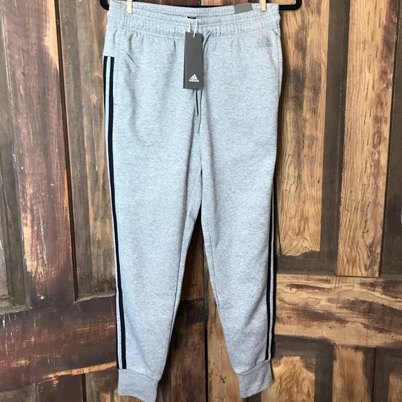 grey adidas sweatpants with black stripes